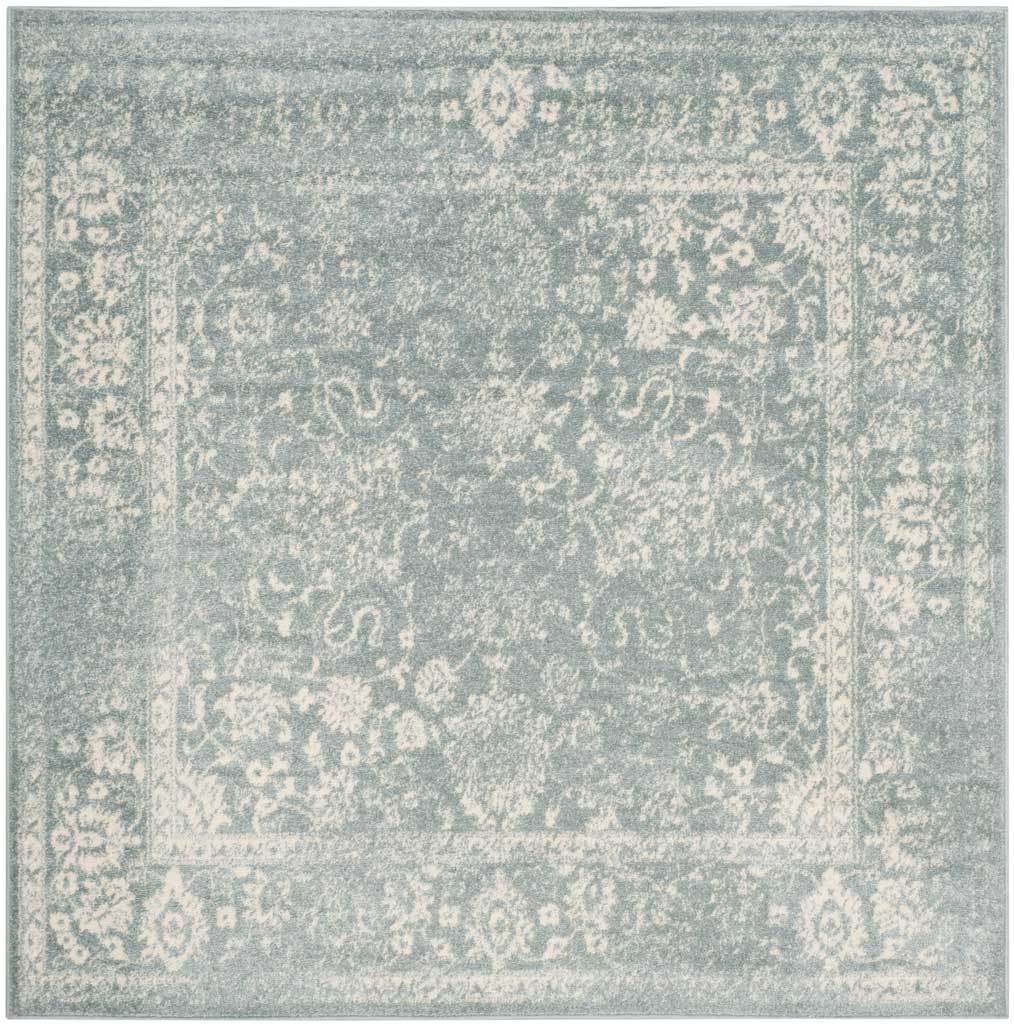 A square slate rug is traced with ivory flowers and a classic border.