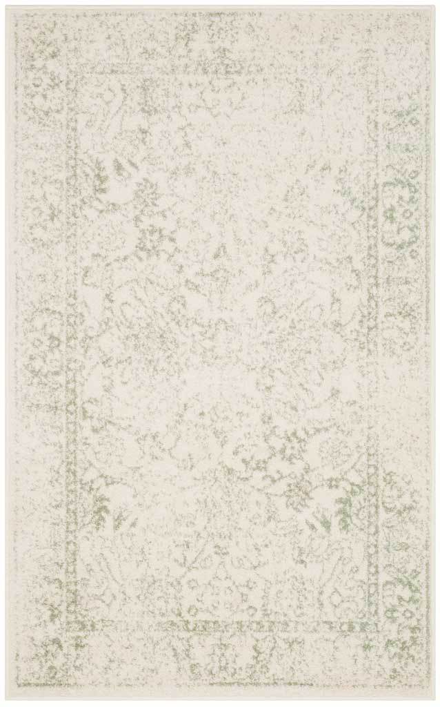 Delicate sage foliage gives this ivory rug a softly weathered finish.