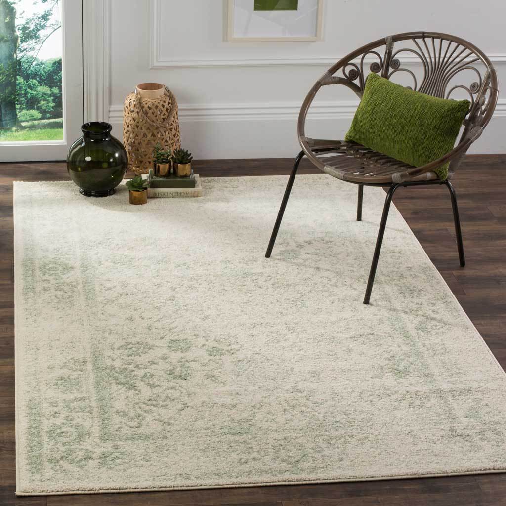 Sage and ivory floral motifs lend a relaxed touch beneath an openwork accent chair.