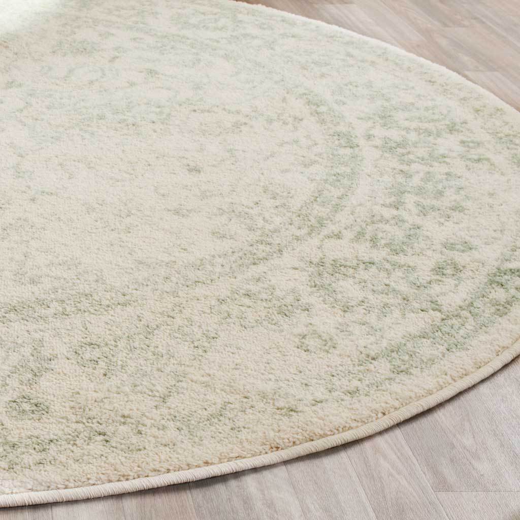 Pale sage floral details blend into ivory pile along a bound curved edge