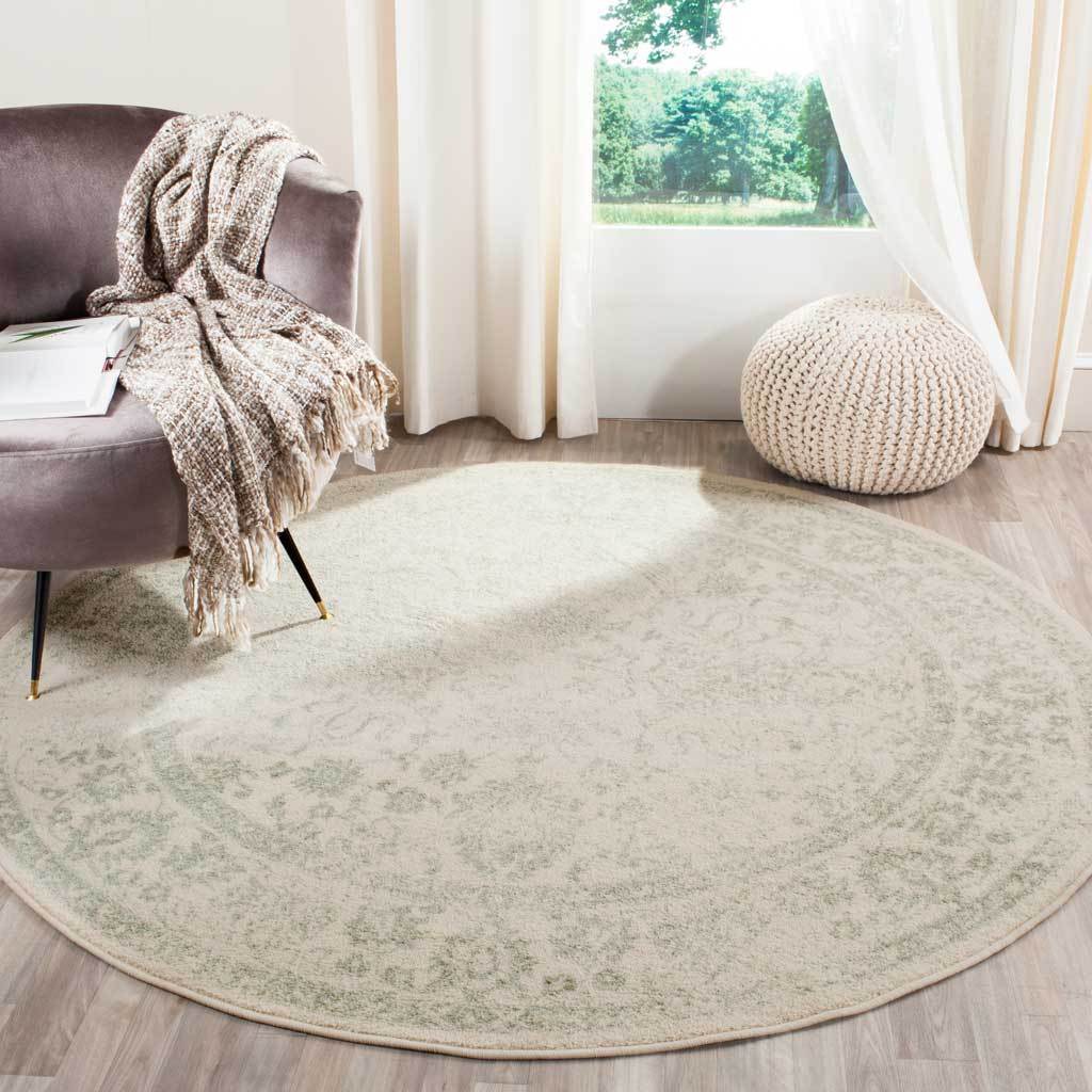 Muted sage accents lend an airy feel to this round ivory floral rug