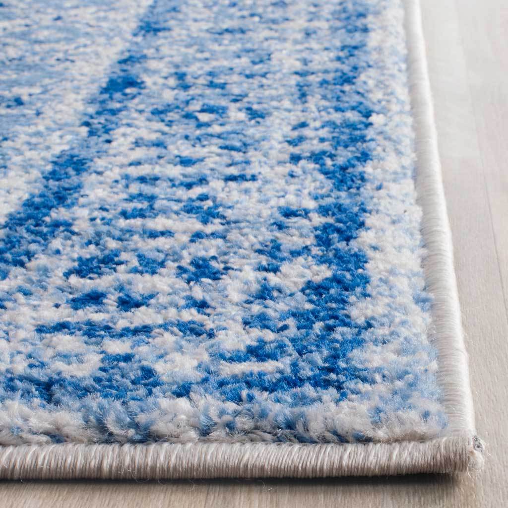 Soft blue and silver pile meets neatly bound edges at the runner rug's corner