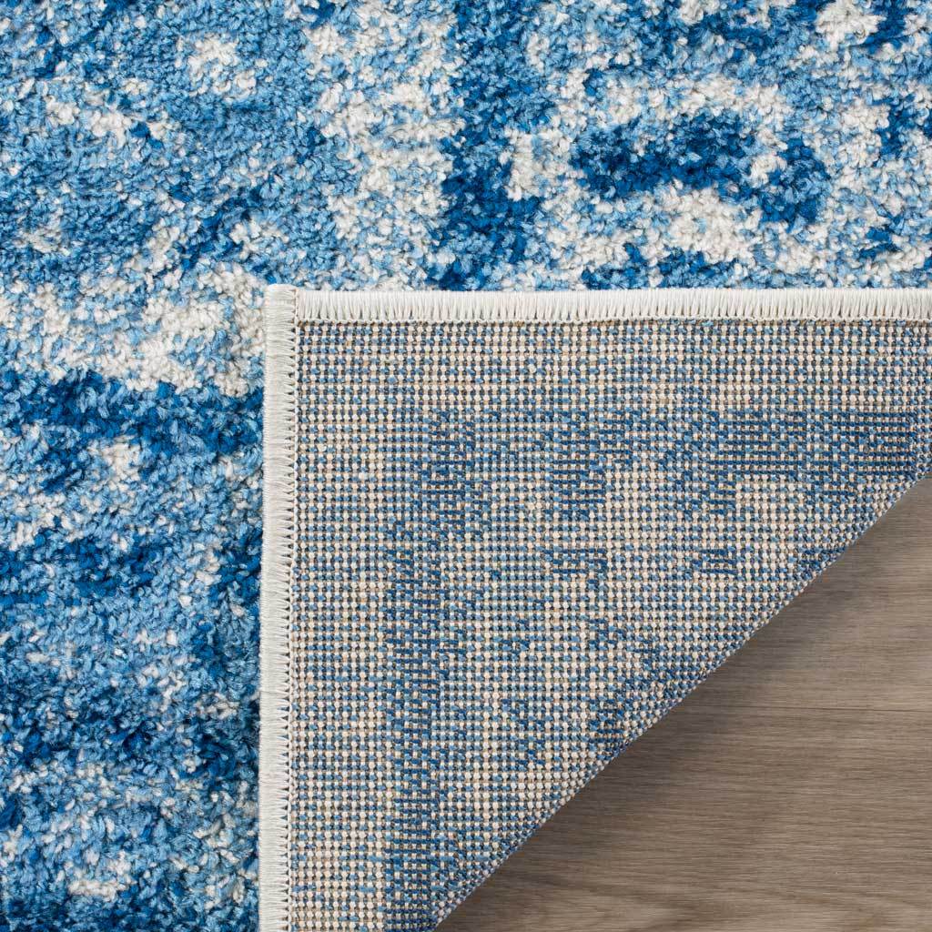 A woven backing and tidy binding support the richly patterned blue and silver surface