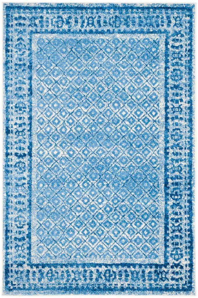 Blue and silver diamond motifs repeat across a rectangular rug with a bold ornamental frame