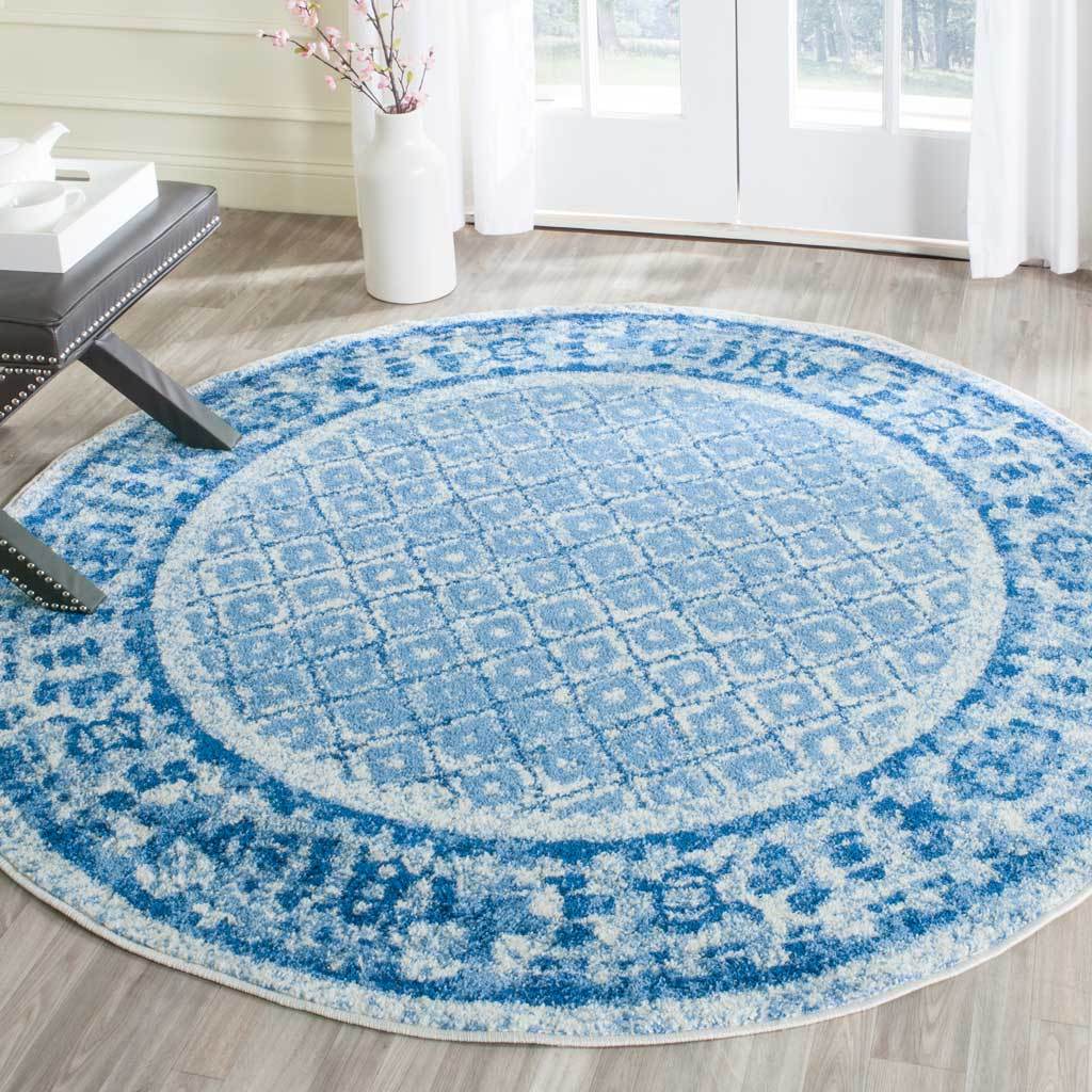 Softly distressed blue and silver patterns give this round rug vintage appeal