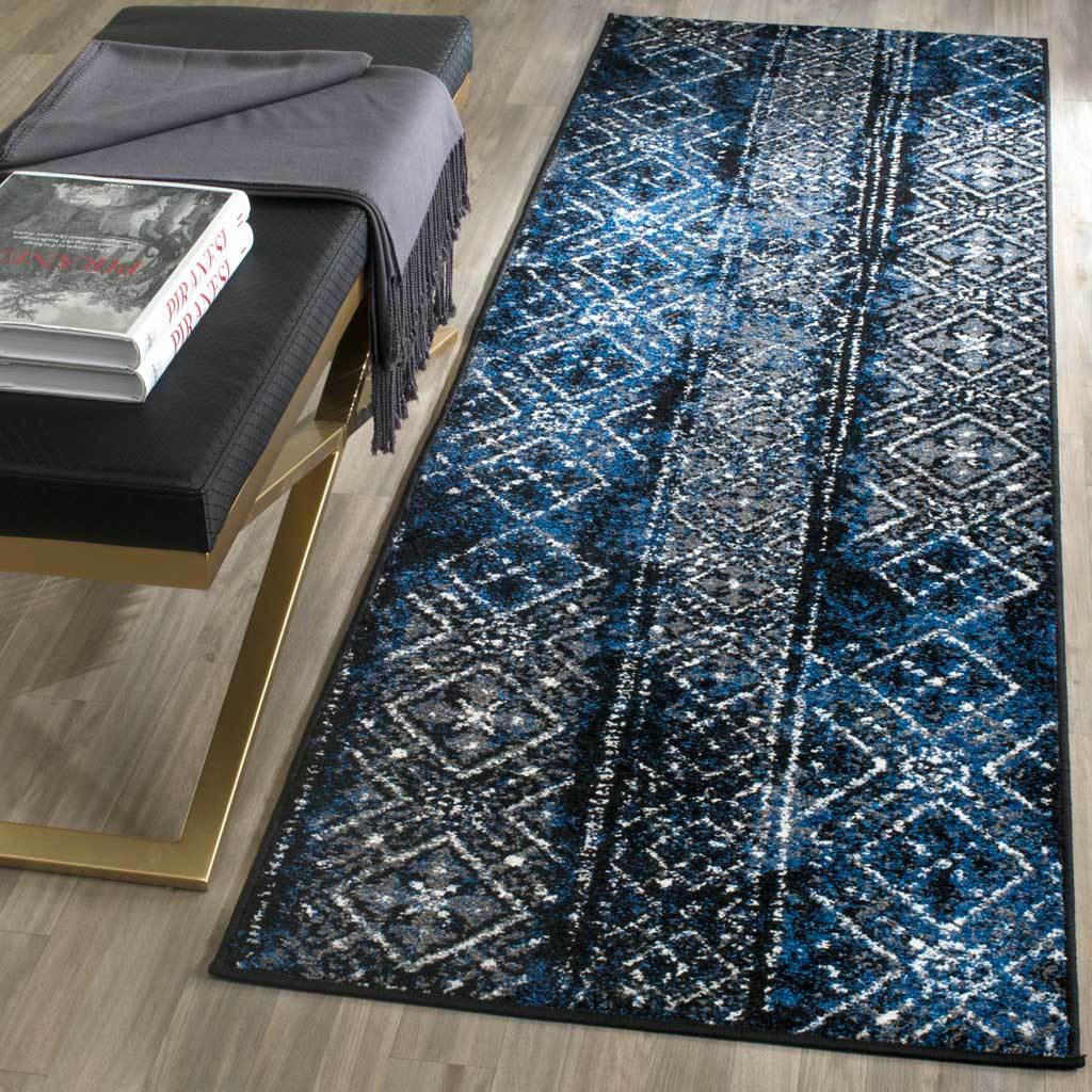Blue and black runner lends vivid color and weathered geometric detail beside a bench.