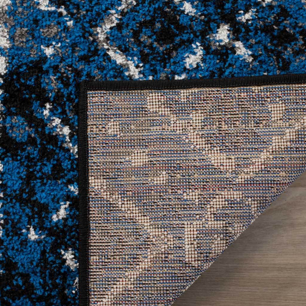 Tightly woven backing and black binding finish this richly colored geometric rug