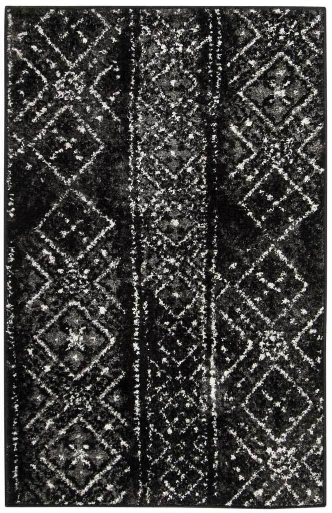 Black and silver accent rug adds dramatic contrast with distressed diamond patterns