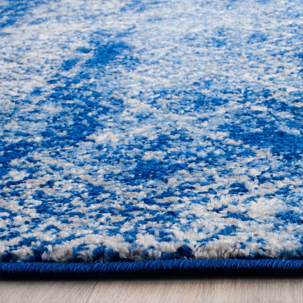 A blue bound edge accents the textured silver and blue pile and its mottled pattern.