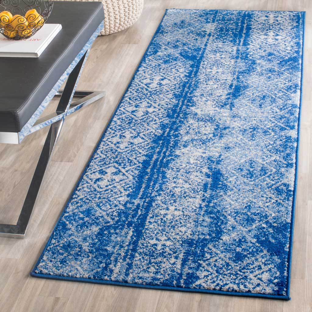 Silver and blue runner brightens wood floors with faded diamonds and tonal bands.