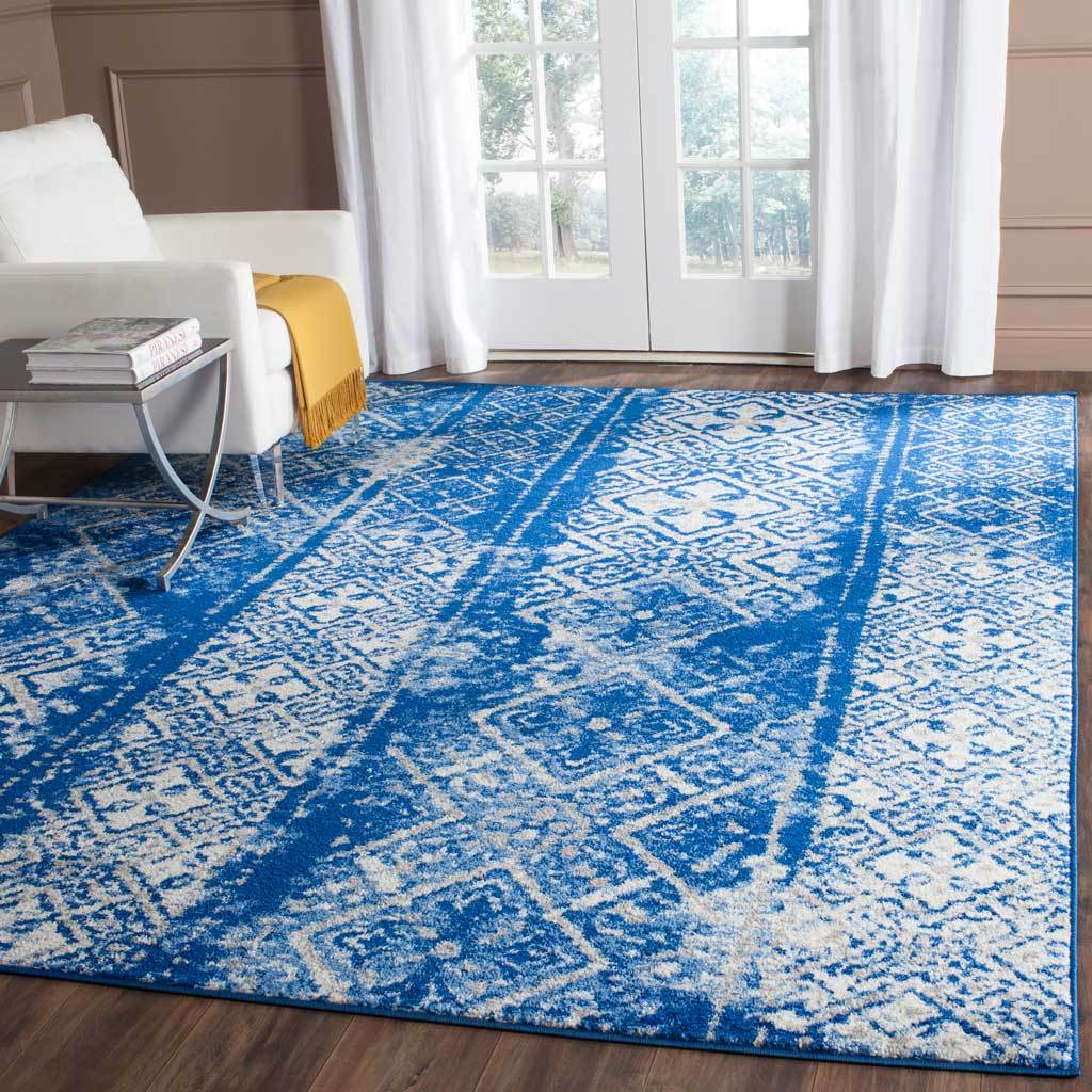 Bright blue geometric bands animate the silvery ground of this expansive area rug