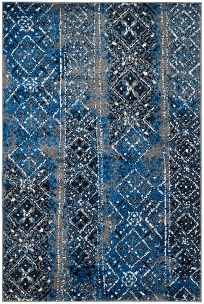A rectangular rug blends distressed navy and cobalt motifs with silvery gray accents
