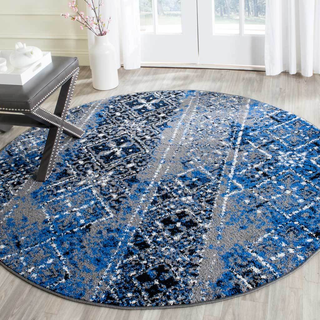 Distressed blue and silver motifs bring eclectic color to this patterned round rug.
