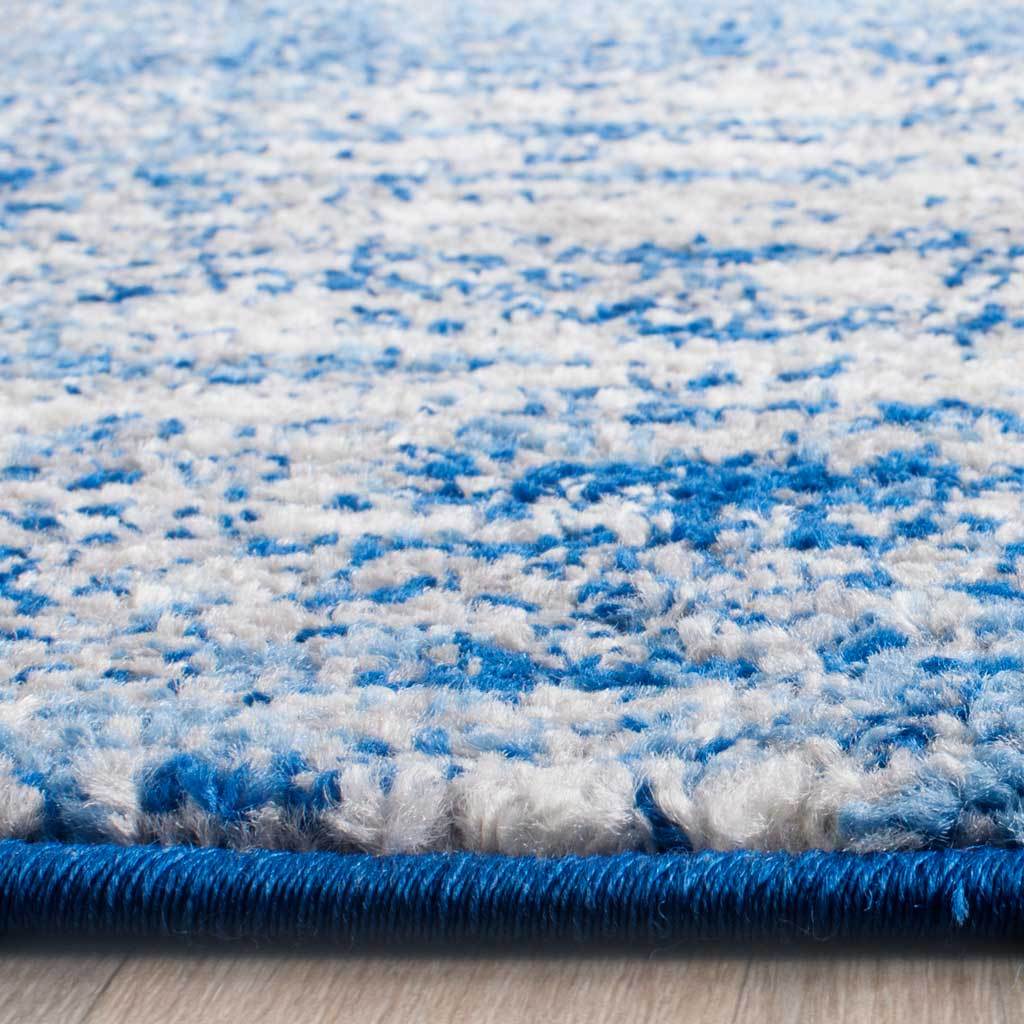 Blue and pale silver fibers meet a neatly bound blue edge for a polished finish