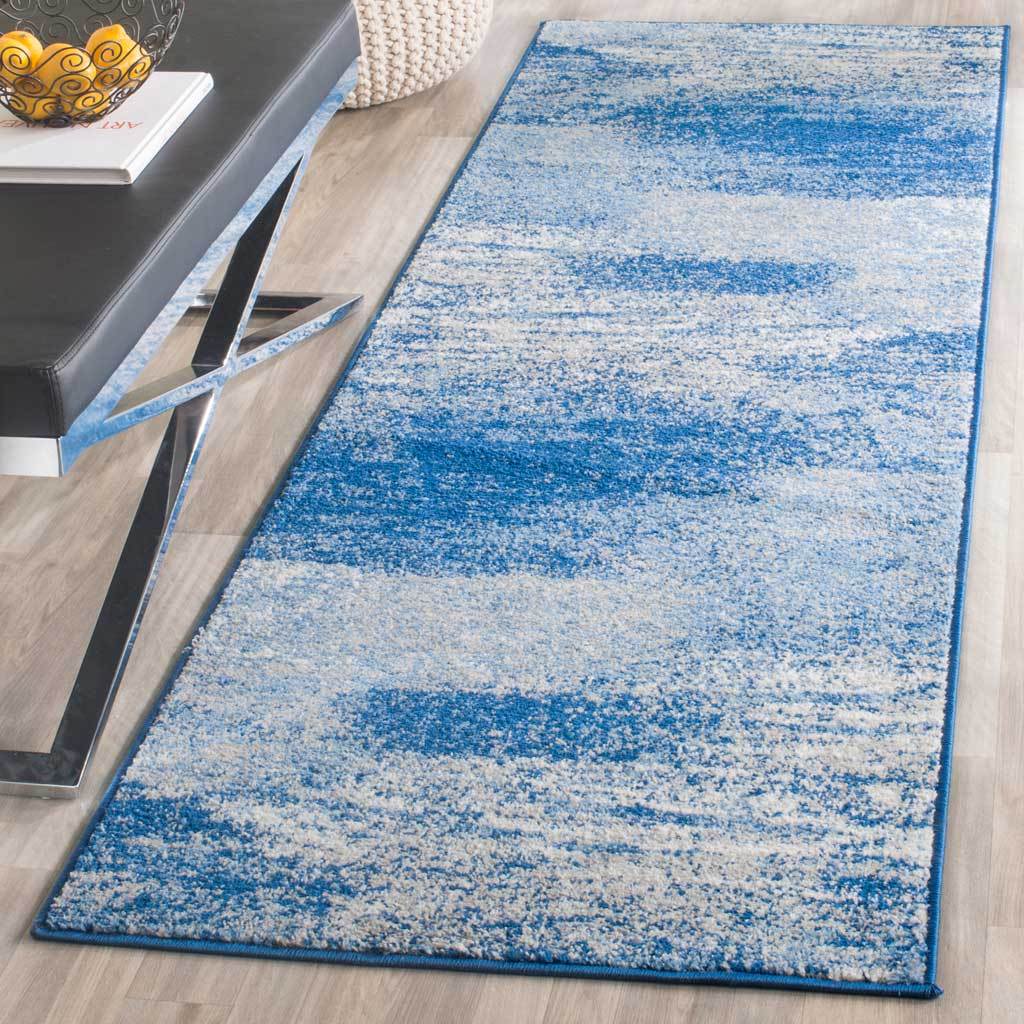 A silver and blue abstract runner brings cool color to a space with modern furnishings