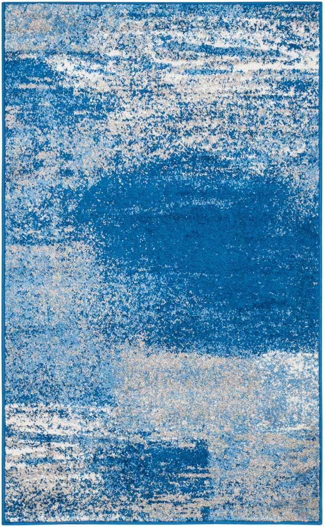 Compact silver and blue rug with deep blue swaths over a softly mottled ground
