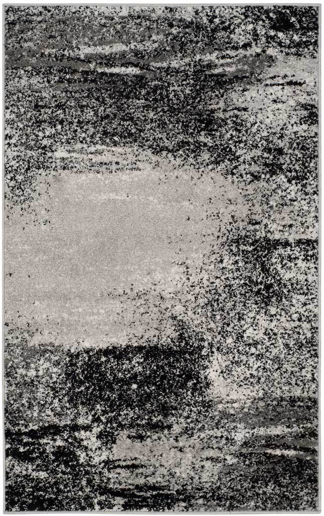 Compact silver and charcoal rug with a high-contrast, distressed brushstroke pattern