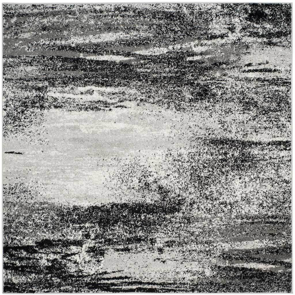 Square silver and charcoal rug with layered dark streaks and a softly faded center