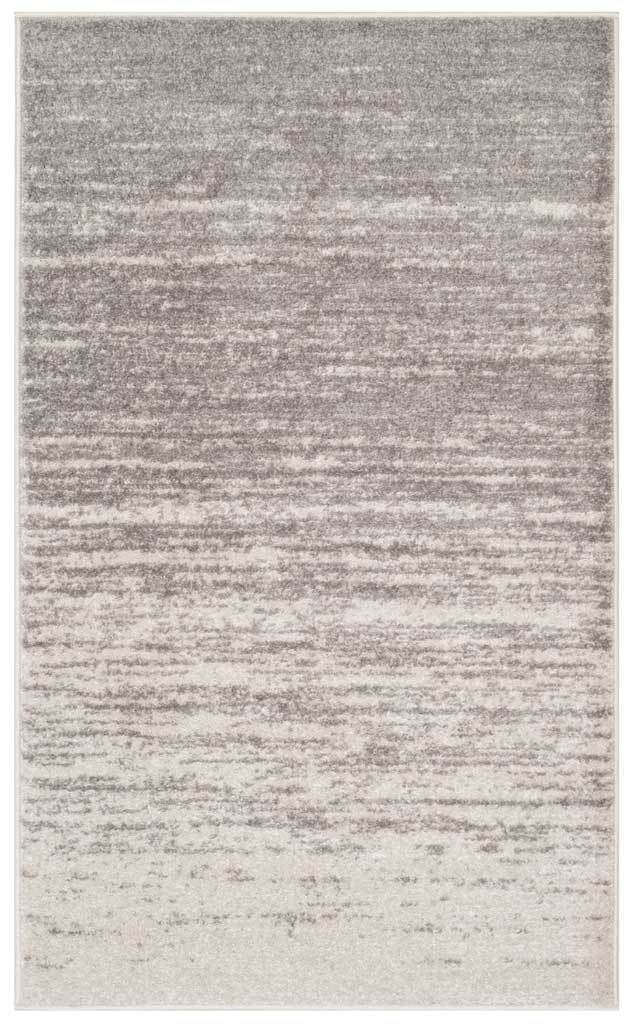 Deep gray streaks soften into pale gray across this compact, lightly distressed rug.