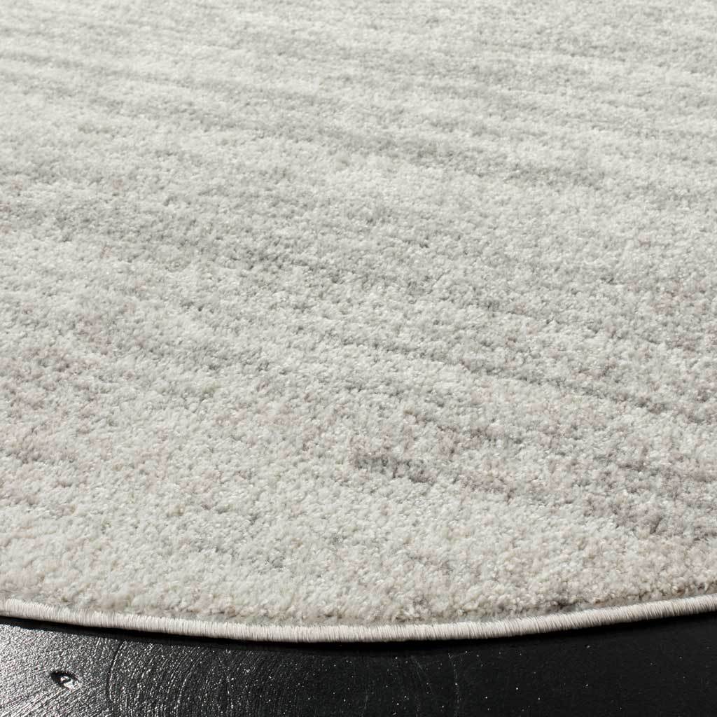 Soft gray fibers and flecks of darker gray meet a clean bound edge
