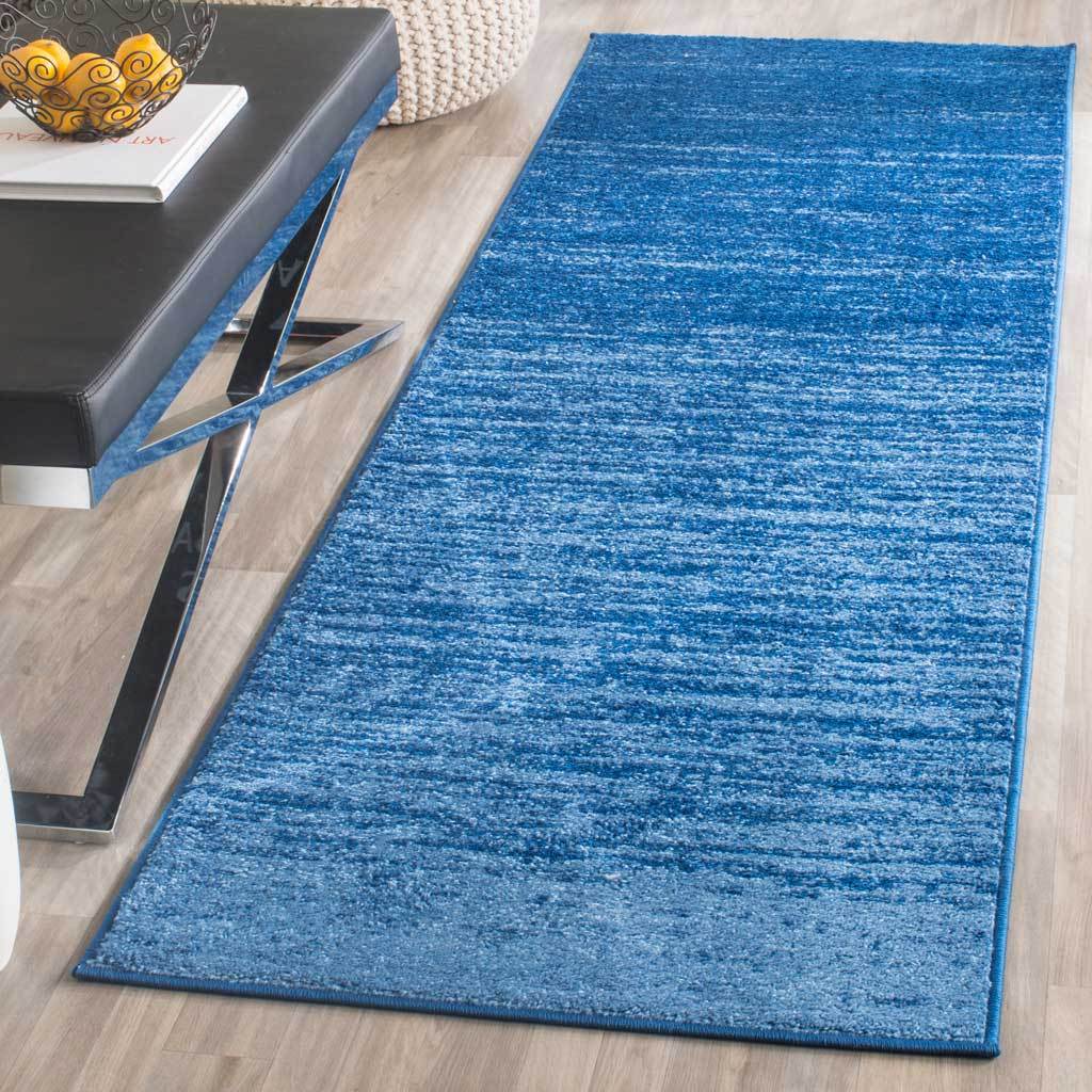 Bright blue runner rug layers fine, faded streaks over deep blue for an energetic floor accent