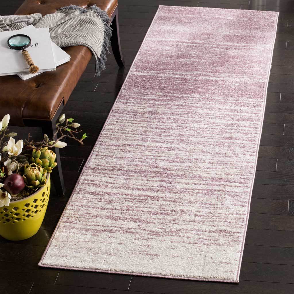 Purple striations soften into cream across this slim, contemporary runner rug