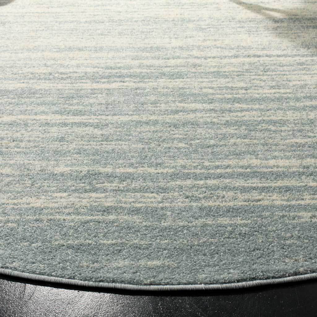 Mottled slate and cream pile ends in a smoothly bound, curved edge