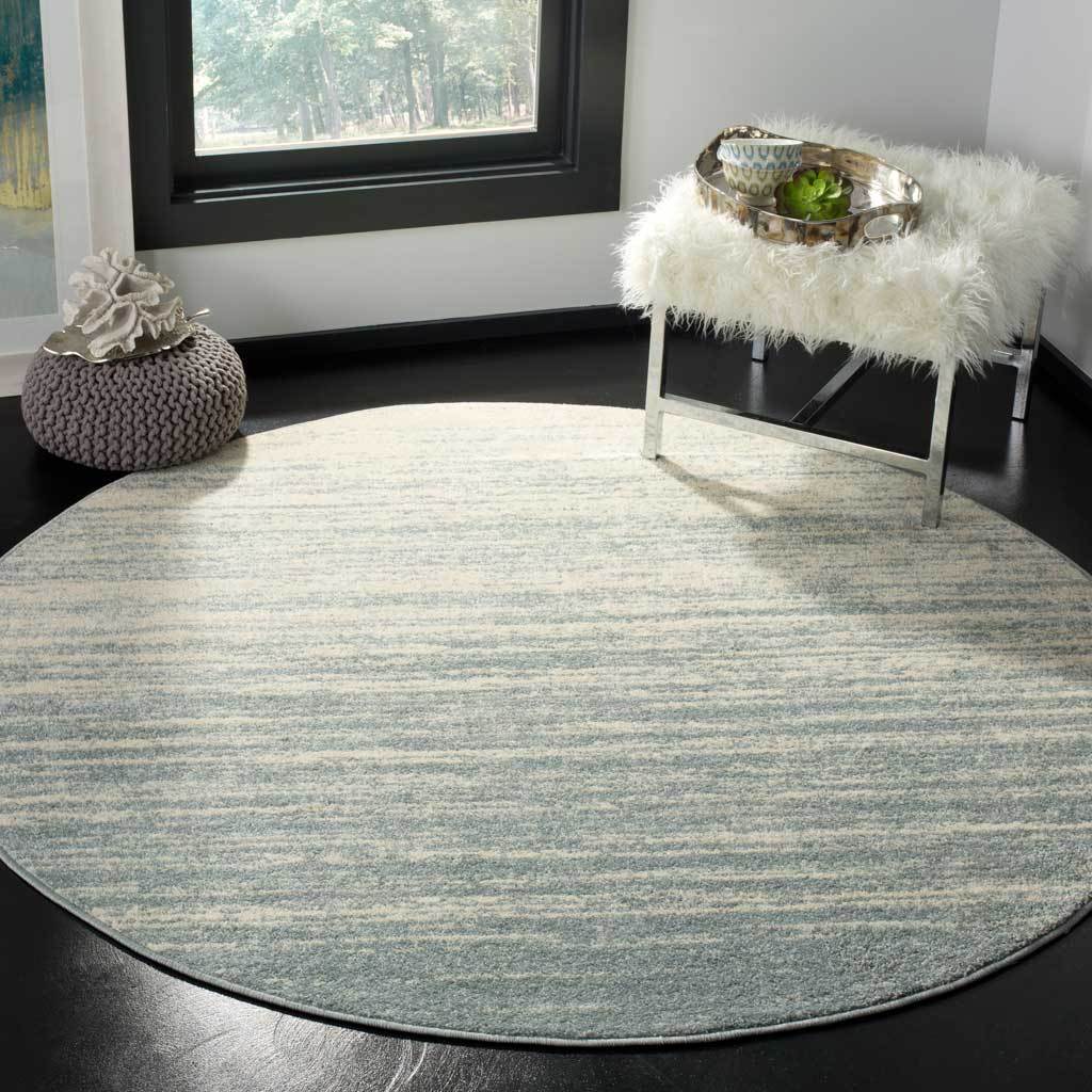 Subtle cream streaks soften this round rug's slate-colored texture