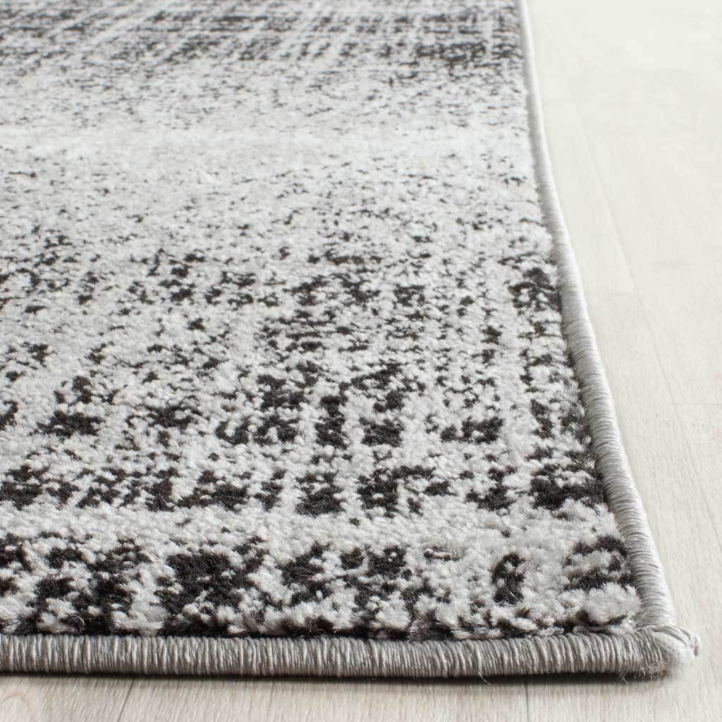 Silver and black flecked pile is framed by tightly wrapped edges and subtle tonal shifts
