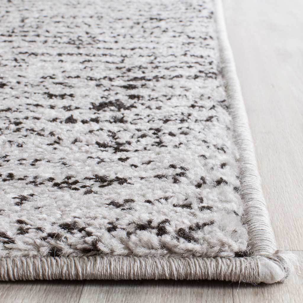 Soft black and silver pile meets a neatly bound edge on this textured runner rug