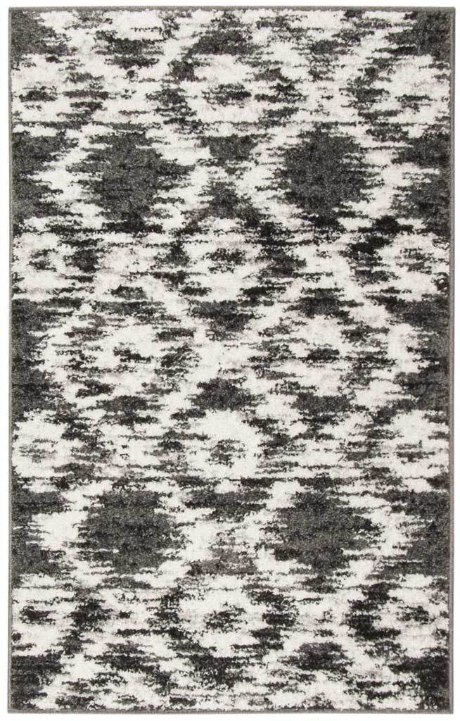 Compact charcoal and ivory accent rug pairs bold diamonds with a mottled abstract pattern