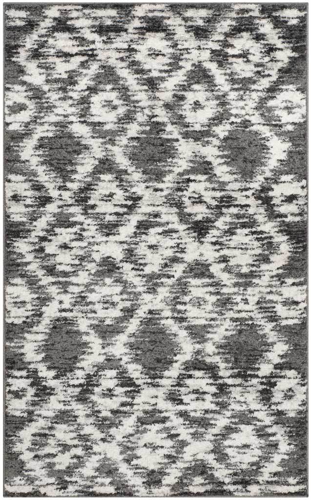 Charcoal and ivory rug features rhythmic diamond rows softened by a worn-in abstract effect