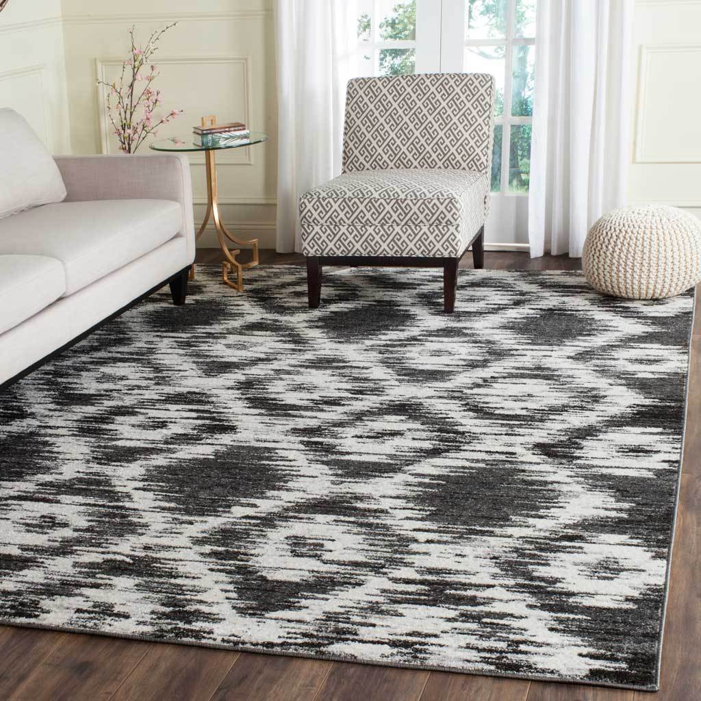 Charcoal and ivory diamonds create a vivid focal point beneath a sofa and patterned armchair