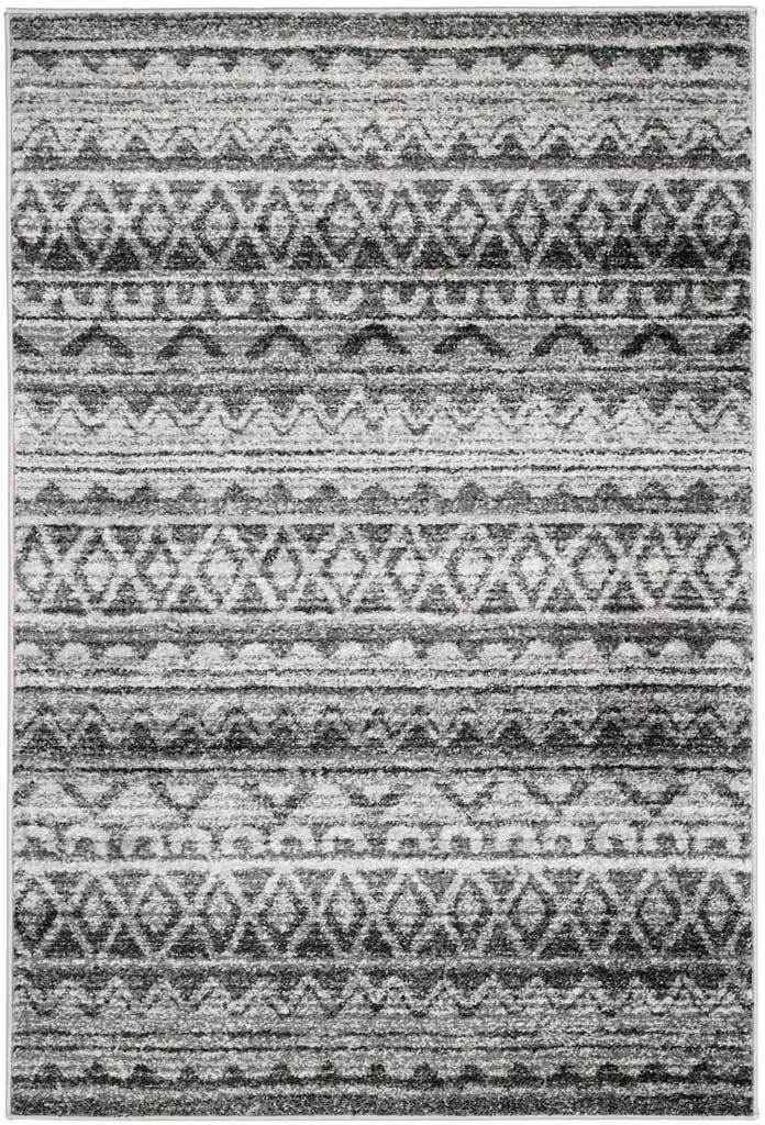 Ivory and charcoal chevrons, diamonds and stripes add graphic appeal to this rug.