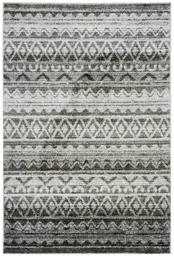 Alternating charcoal diamonds and ivory bands create rhythmic texture across this rug.