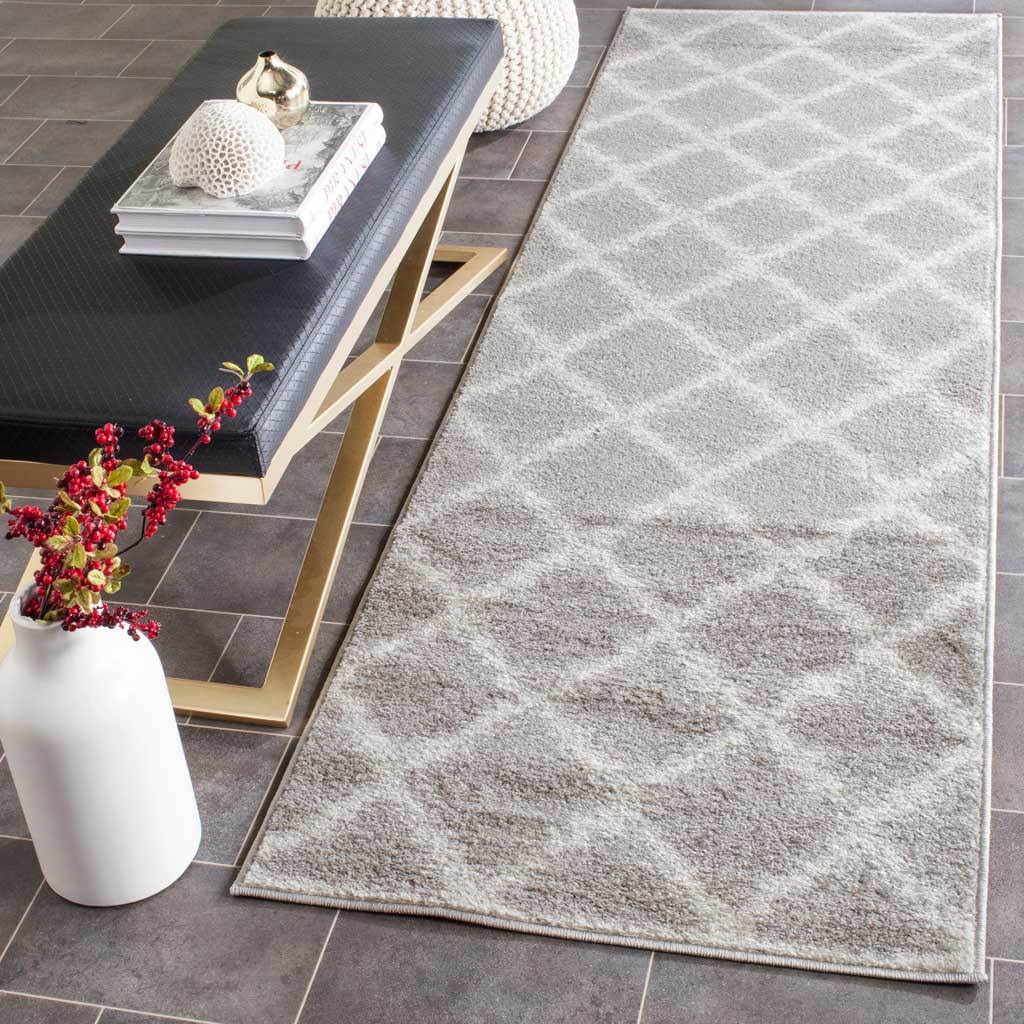 A silver and ivory diamond-patterned runner brings a soft, modern look to tiled floors.
