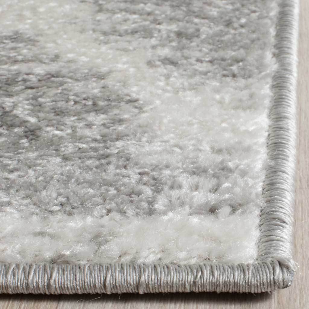 Soft silver and ivory fibers meet neatly wrapped edges for a finished look