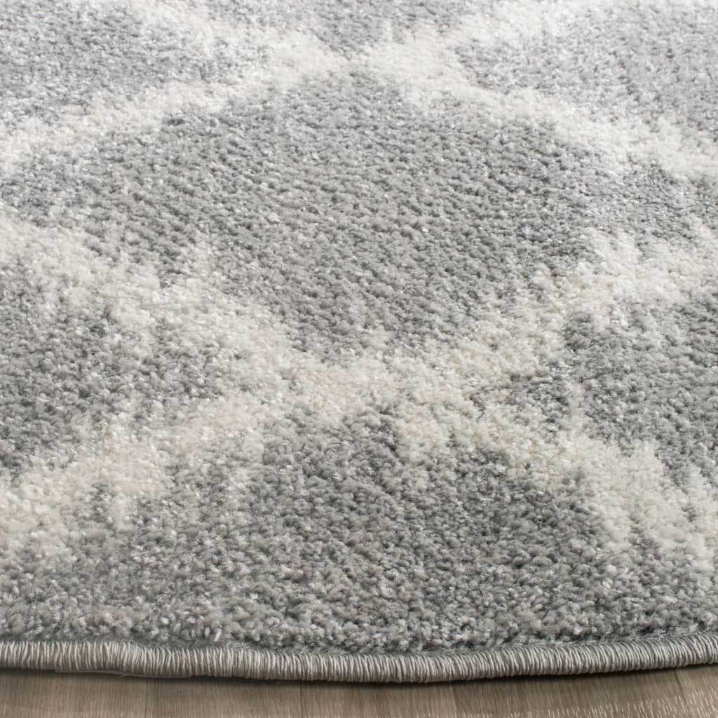 Textured silver and ivory pile meets a neatly bound edge for a polished finish.