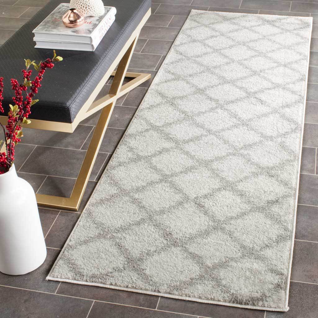 Ivory and silver diamond trellis runner brings soft texture to a sleek tiled space.