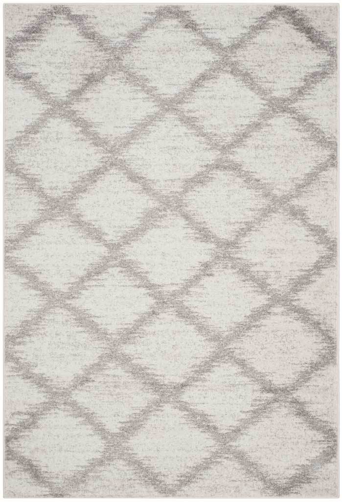 Ivory area rug with oversized silver diamonds and a softly faded finish