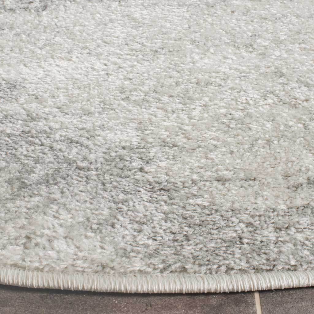 Soft ivory and silver pile meets a neatly bound edge for a tailored finish