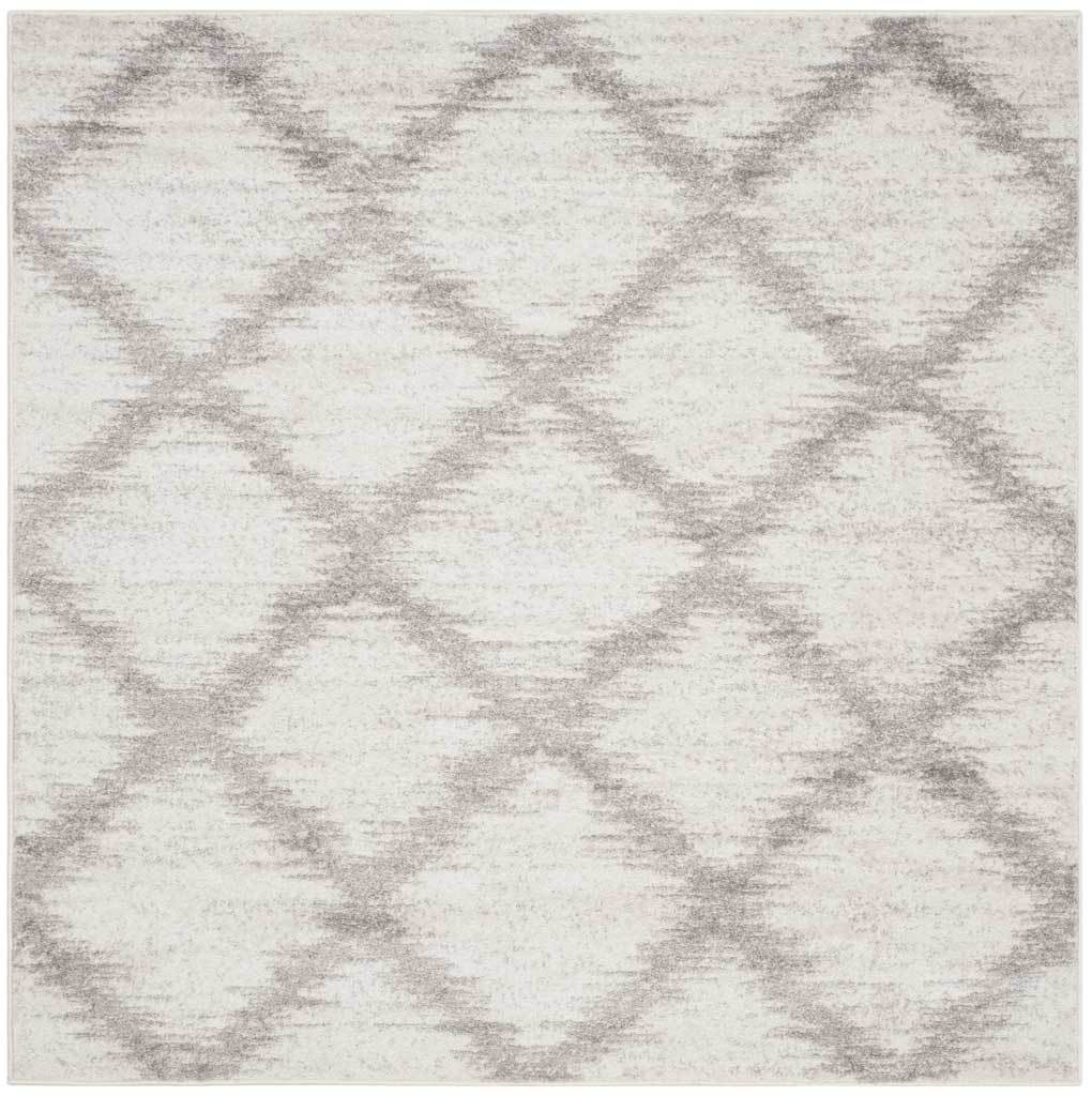Square ivory rug with silver diamond latticework and softly mottled texture