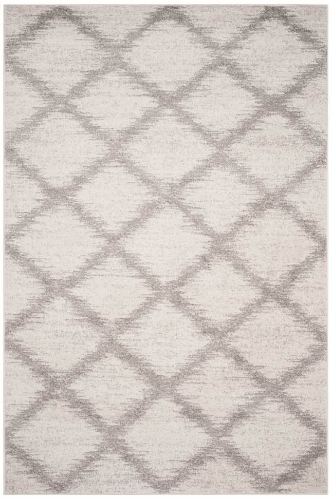 Soft ivory rectangular rug with silver diamond accents and a gently weathered finish