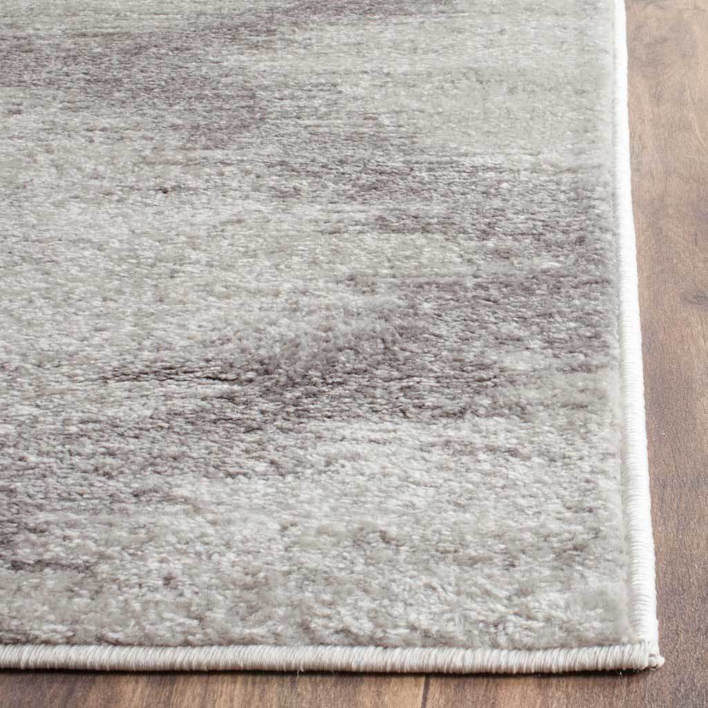 Neatly bound edges frame the softly mottled ivory and silver pile