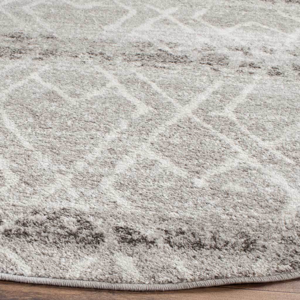 Ivory geometric lines cross textured silver pile above a neatly bound curved edge