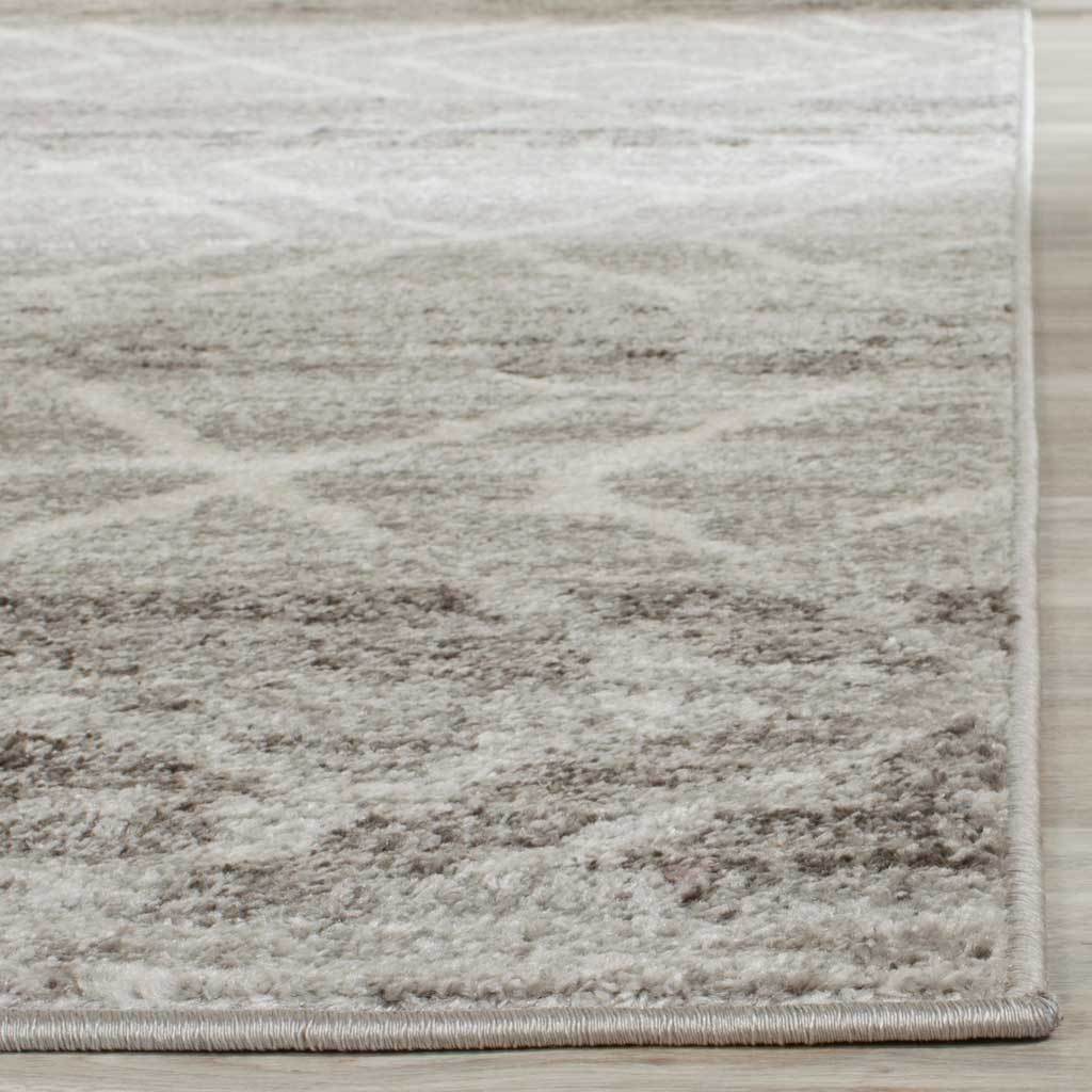 Bound edges frame a softly textured pile in muted silver and ivory tones