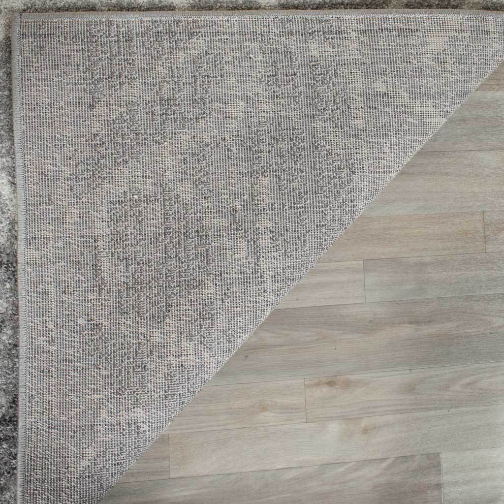 Tightly woven backing and neatly bound edges finish the patterned area rug