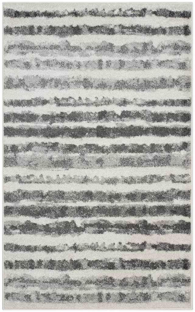 Compact ivory rug features wavy charcoal stripes and a softly distressed look
