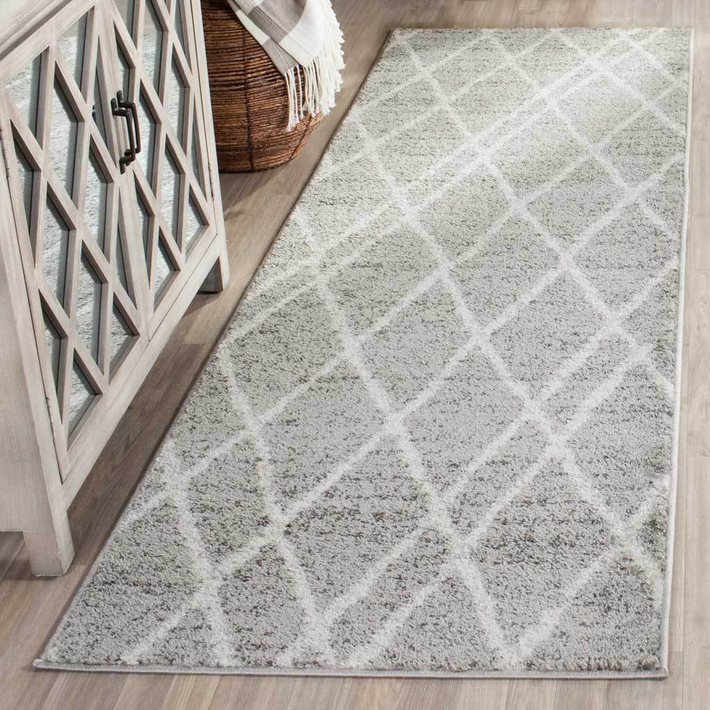 An airy ivory lattice adds geometric pattern to a textured silver runner.