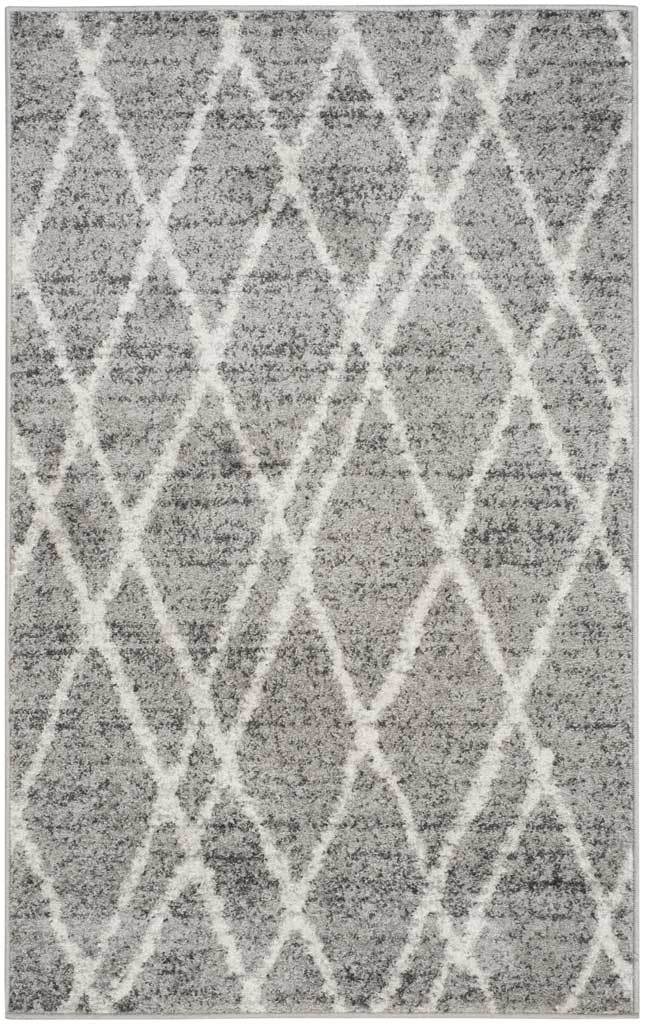 An ivory crisscross trellis brightens the soft gray tones of this compact area rug.